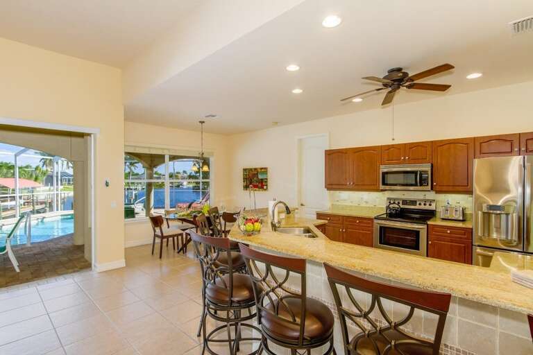 The Kitchen Offers Views of the Living Room and is Open to the Formal Dining Space