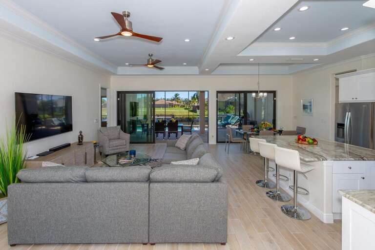 View of the living room, kitchen and dining room when entering the home