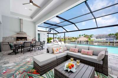 Covered Lanai Lounge Area with TV, Outdoor Kitchen and Al Fresco Dining