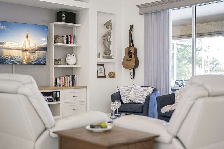 Fish & Sips Living Room offers a View of the Lanai and Pool
