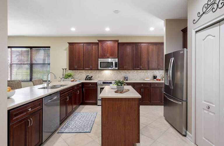 Fountain Villa Features a Large Kitchen with Island and Additional Seating at the Bar