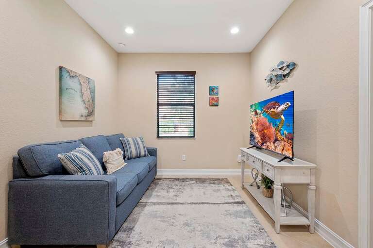 Kick Back and Relax in the Den with Sleeper Sofa and TV