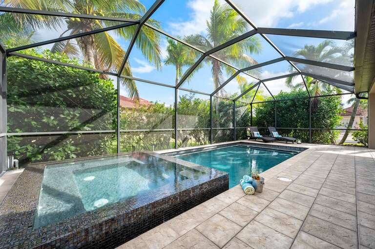 Relax and Enjoy the Florida Lifestyle with this Built in Spa and Tropical Pool