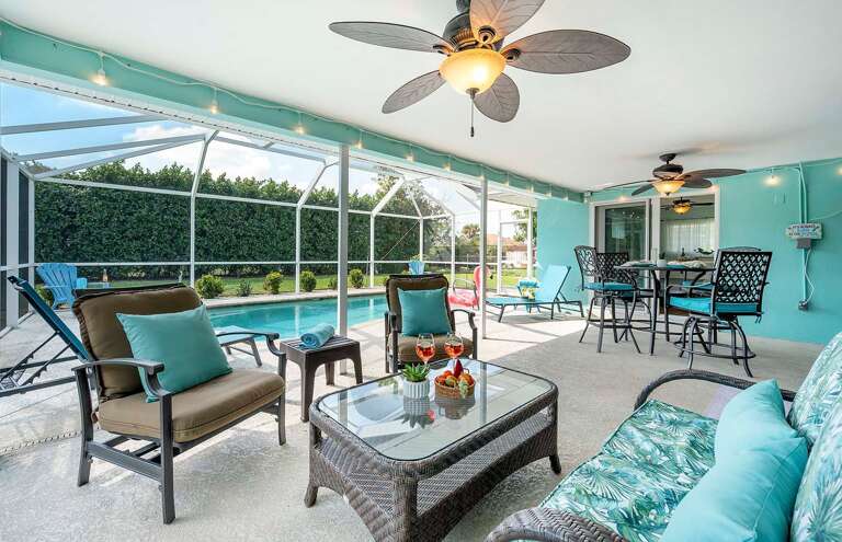 Enjoy Your Backyard Oasis with the Conversation Area under the Covered Lanai