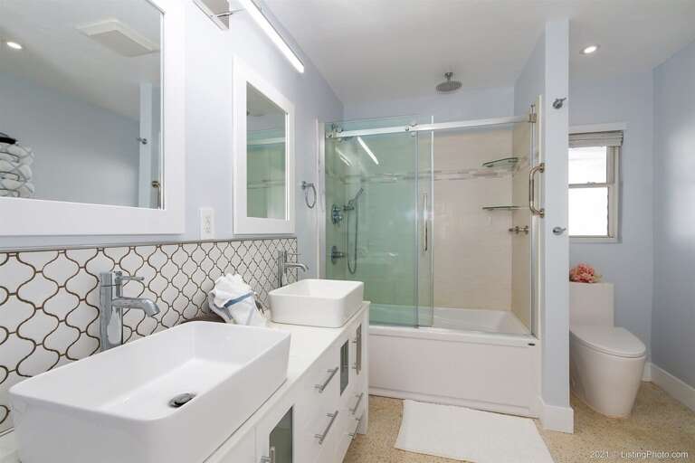 Guest Bathroom with Dual Sinks and Shower Tub Combo