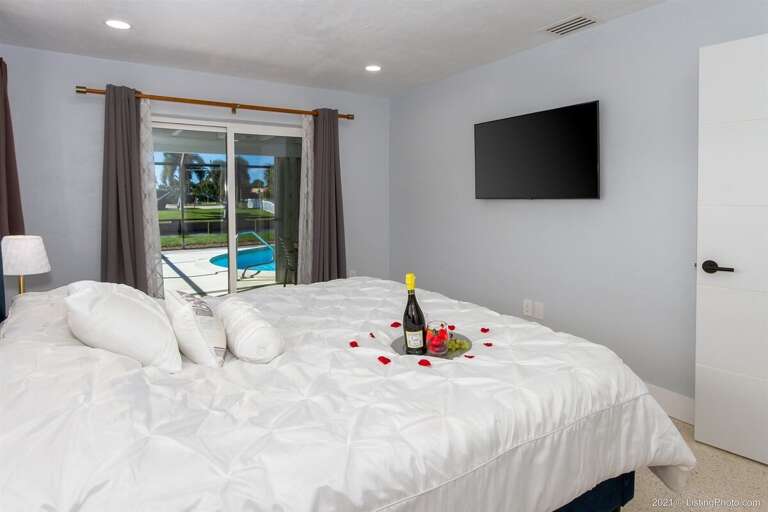 Main King Bedroom with Access to Lanai and Pool Area