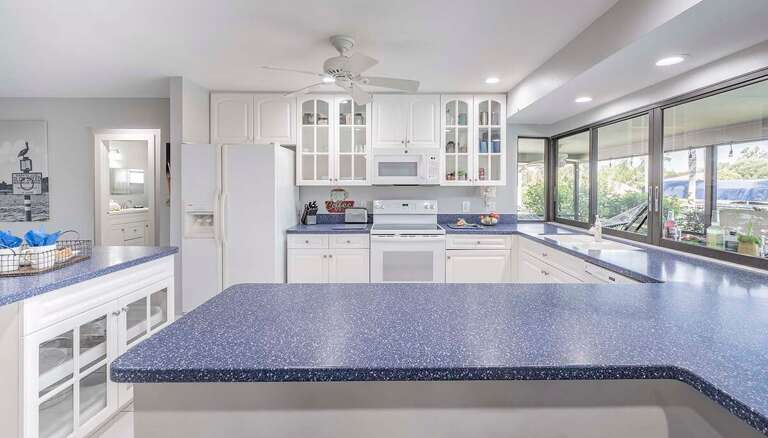 Kitchen with Windows that Open Up to Pool and Lanai