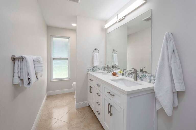 Guest Bathroom with Dual Sinks and Shower