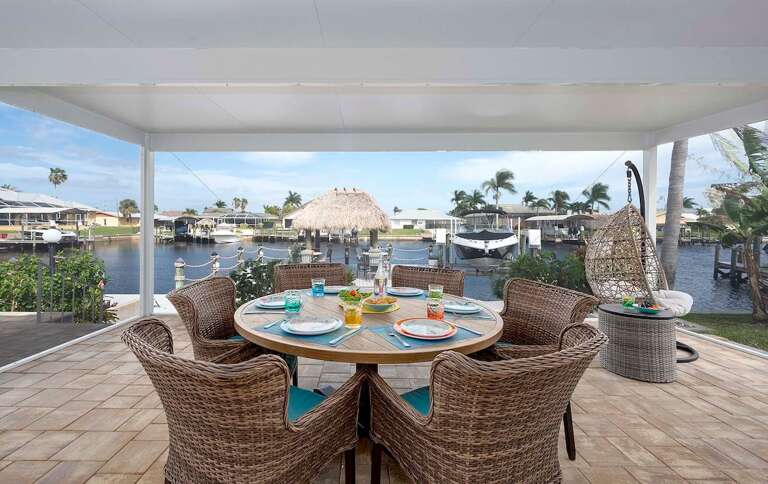Outdoor Dining Space with Views of the  Direct Gulf Access Canal