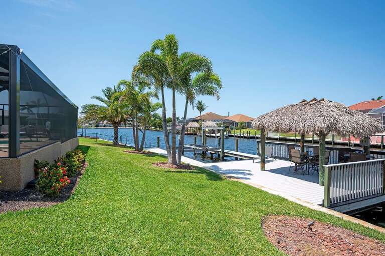 Walkway to the Dock and Tiki Hut Area Home is Surrounded with a Fenced Yard