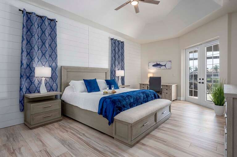 Main Bedroom With Shiplap Wall and French Doors to Patio as well as Writing Desk