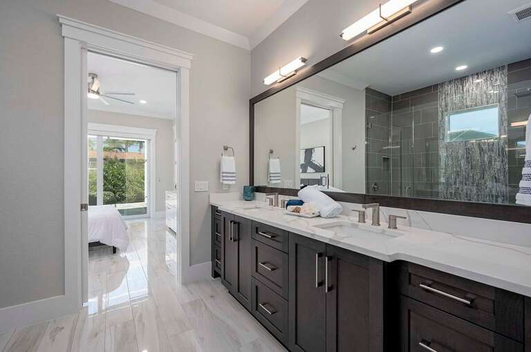 Guest Jack and Jill Bathroom Connecting the two Guest Bedrooms with Dual Sinks and Walk in Shower