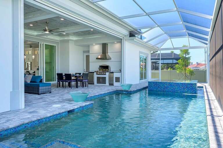 Outdoor Pool and Patio with Spa and Outdoor Kitchen (Built in BBQ not available for Guests) A Stand Alone BBQ is provided for Guest Use
