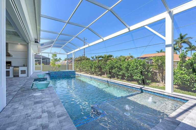 Pool with Privacy Shrubbs and Sun Deck with Water Feature