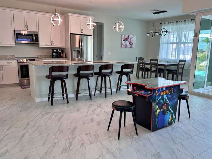 Large Open Living Area Combining Kitchen, Dining and Living Room with Game Station for Kids