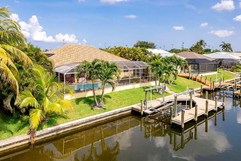 Backyard View of Canal and Boat Dock of Sand By Me
