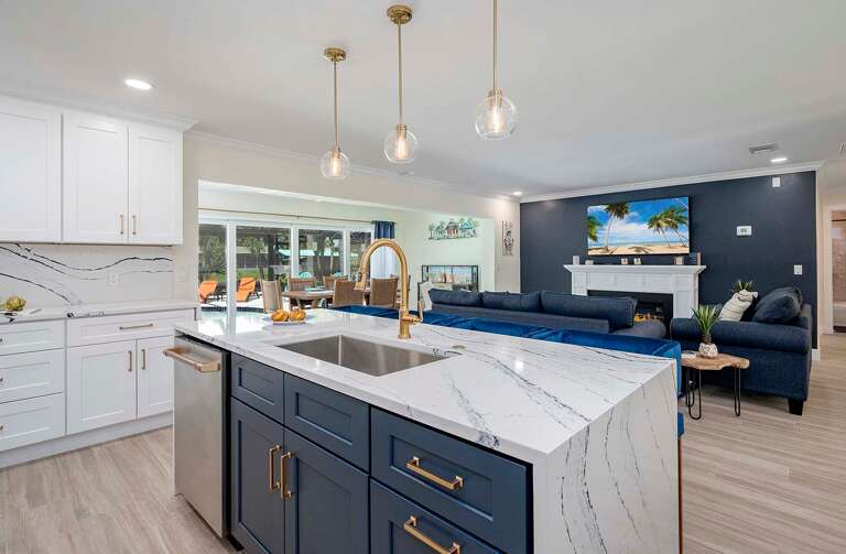 Kitchen with Waterfall Island and View of the Living Room and Dining Room