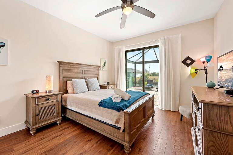Queen Bedroom with Access To Lanai and Pool Area