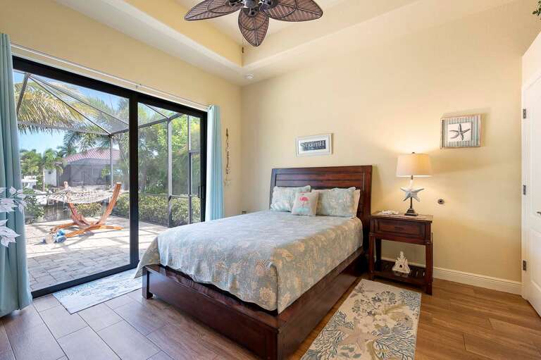 Guest Bedroom with Queen Size Bed and Access to the Pool Area