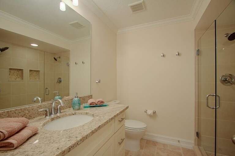 Hallway Bathroom with Shower and Sink Next to Queen Bedroom