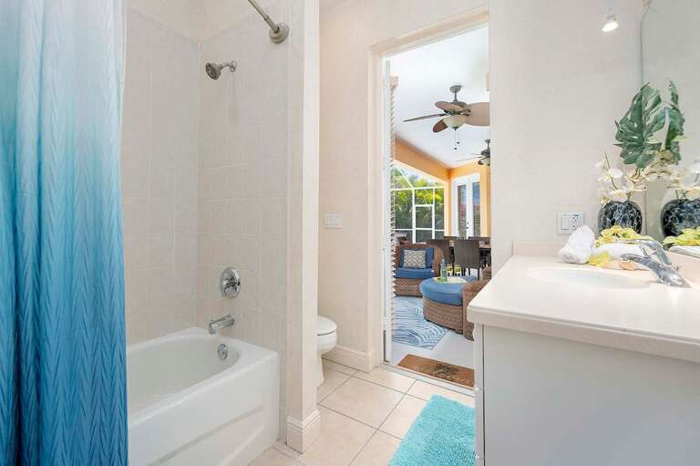 Guest Bathroom with Hallway Access and Access from Pool with Shower/Tub Combo