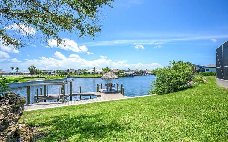 Large Backyard with Dock and Tiki Hut