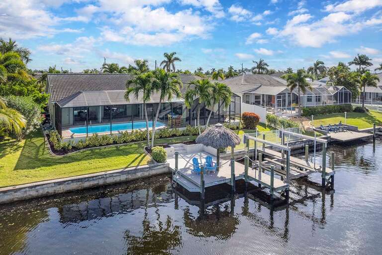 Rear View of Boat Dock and Lift as well as Tiki Hut