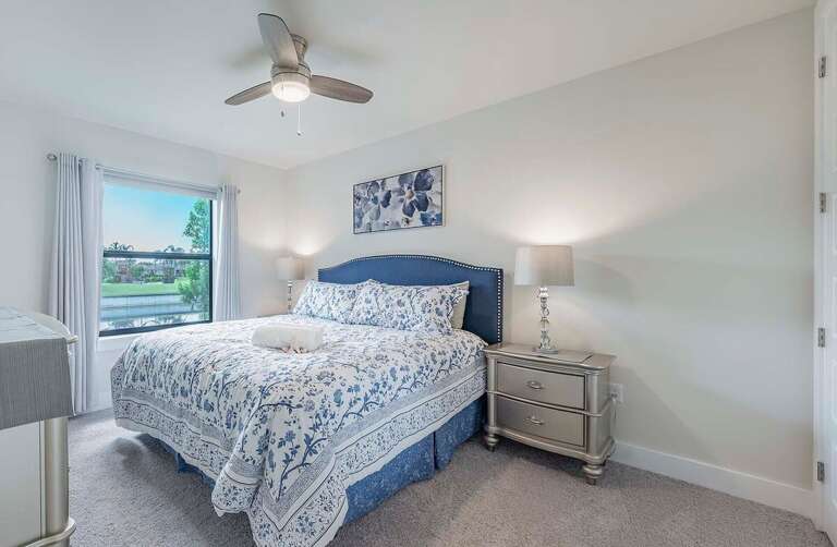 Guest Bedroom Featuring a King Bed and Pool View