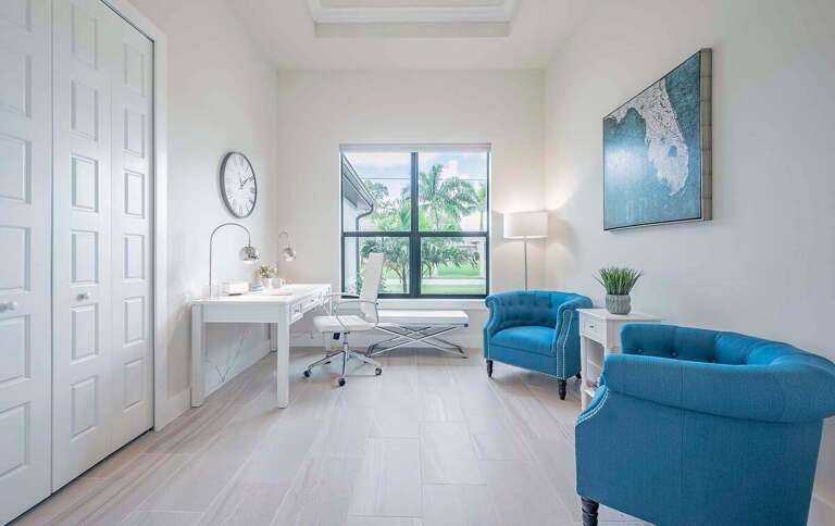The Office is Comfortably Furnished and Offers a Work Desk with Garden View