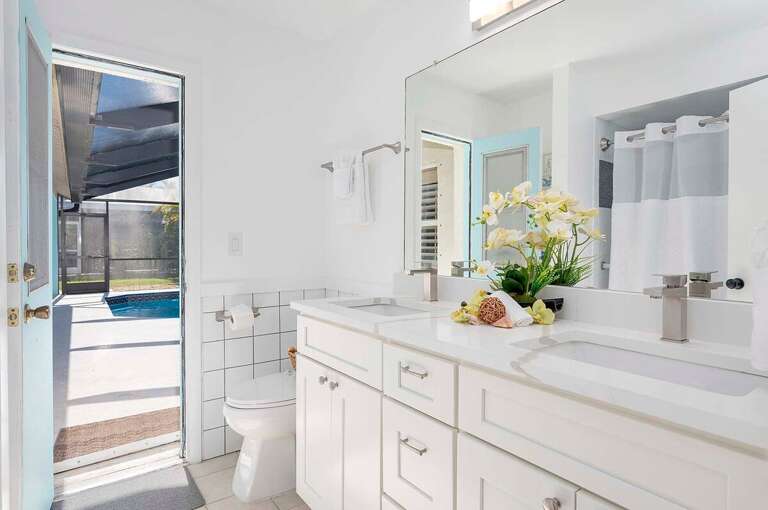 Guest Hallway/Pool Bathroom with Shower/Tub Combo and Dual Sinks