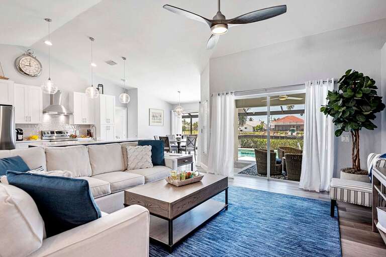 Open Living with Comfortable Living Room Couch and Views of the Pool and Lanai