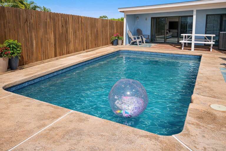 Poolside Patio With Inflatable Ball And Picnic Table
