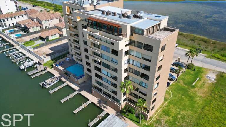 Building Beside Blue Body Of Water With Rooftop Amenities