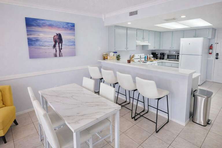 Kitchen With Counter, Dining Table, Beach Painting