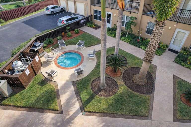 Courtyard With Circular Pool, Palm Trees, And Patio Seating