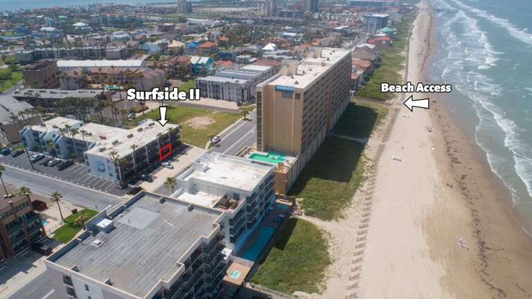 Aerial View Of Buildings Beside Bustling Beach