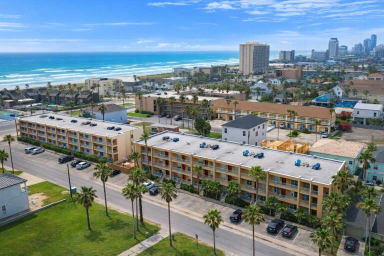 Coastal Complex With Ocean Backdrop, Palm-lined Streets