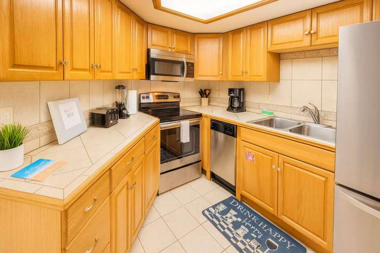 Wooden Cabinets, Stainless Steel Appliances, Tiled Floor, And Countertop Accessories