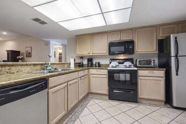 Spacious Kitchen With Stainless Steel Appliances And Wooden Cabinets