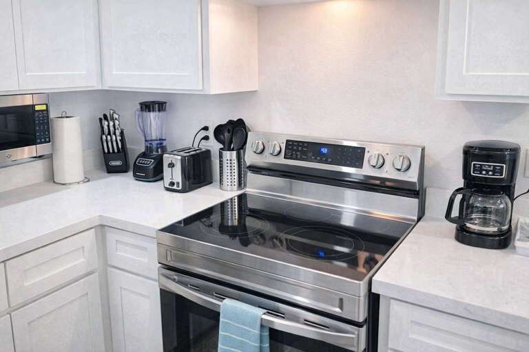 Sleek Kitchen Corner With Stove, Utensils, And Appliances