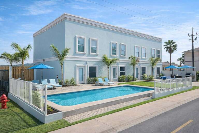 Blue Building, Palm Trees, Poolside Patio, White Fence