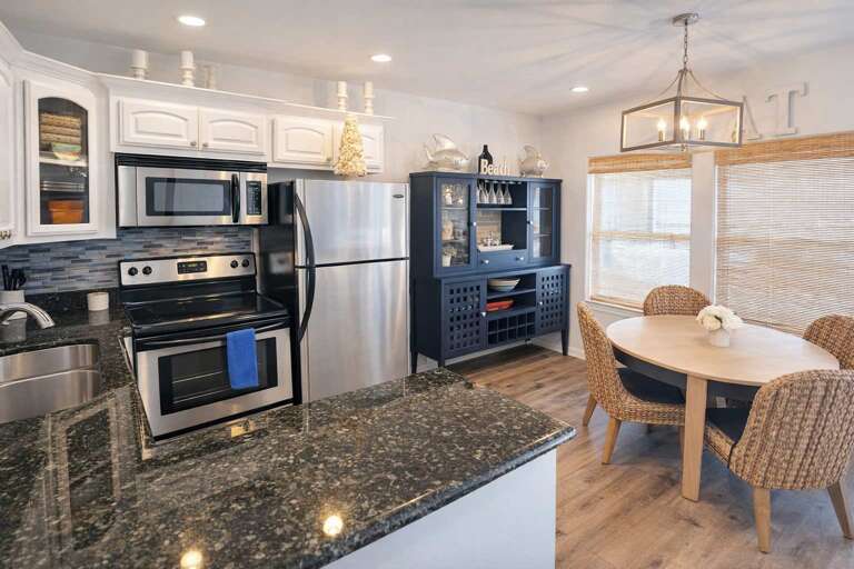 Sleek Kitchen, Stainless Steel, Snug Seating, Sunny Space