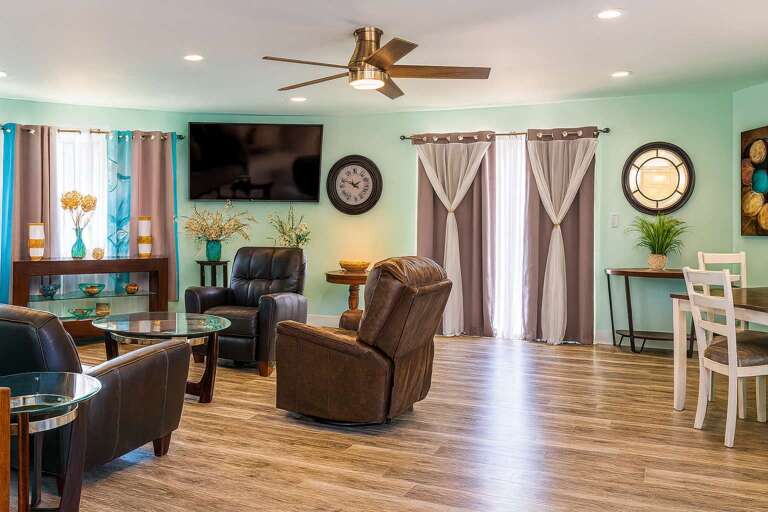 Spacious Seating, Sleek Surfaces, Circular Clock, Ceiling Fan