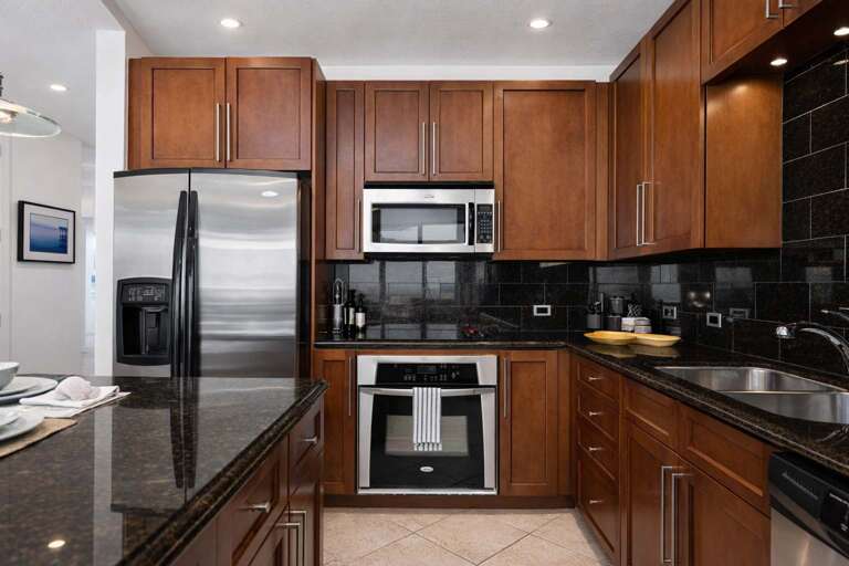 Sleek Stainless Steel And Smooth Wooden Cabinetry Kitchen