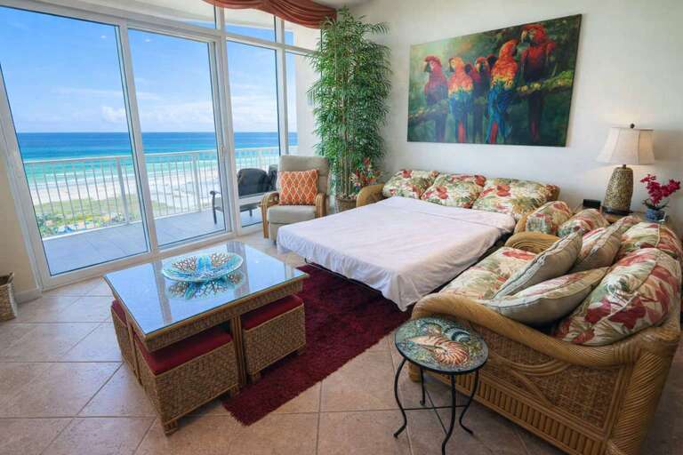Sea-view Suite With Sofa, Glass Table, Lush Plants, And Vibrant Painting