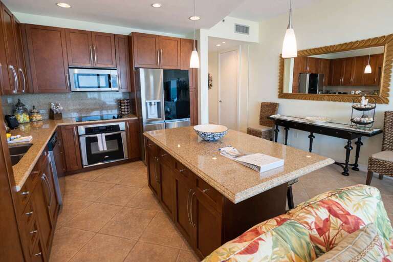 Spacious Kitchen With Island, Stainless Steel Appliances, And Dining Area