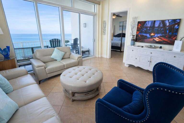 Sea-view Seating, Plush Armchairs, Round Ottoman, Large TV, Balcony Access