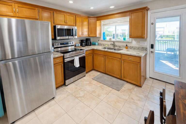 Spacious Kitchen, Stainless Steel Appliances, Wooden Cabinets, Tiled Floor