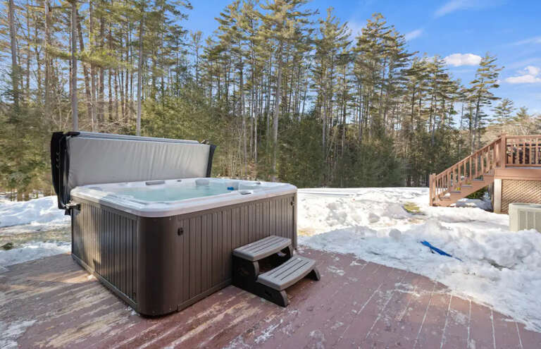 Bubbling Hot Tub Beside Snowy Forest