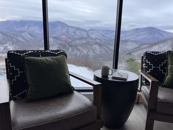 Chairs And Table Overlooking Misty Mountain Vista Through Room Window